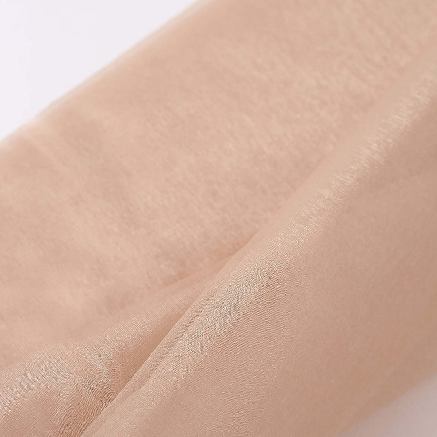 Beige sheer fabric roll for crafting and design projects.