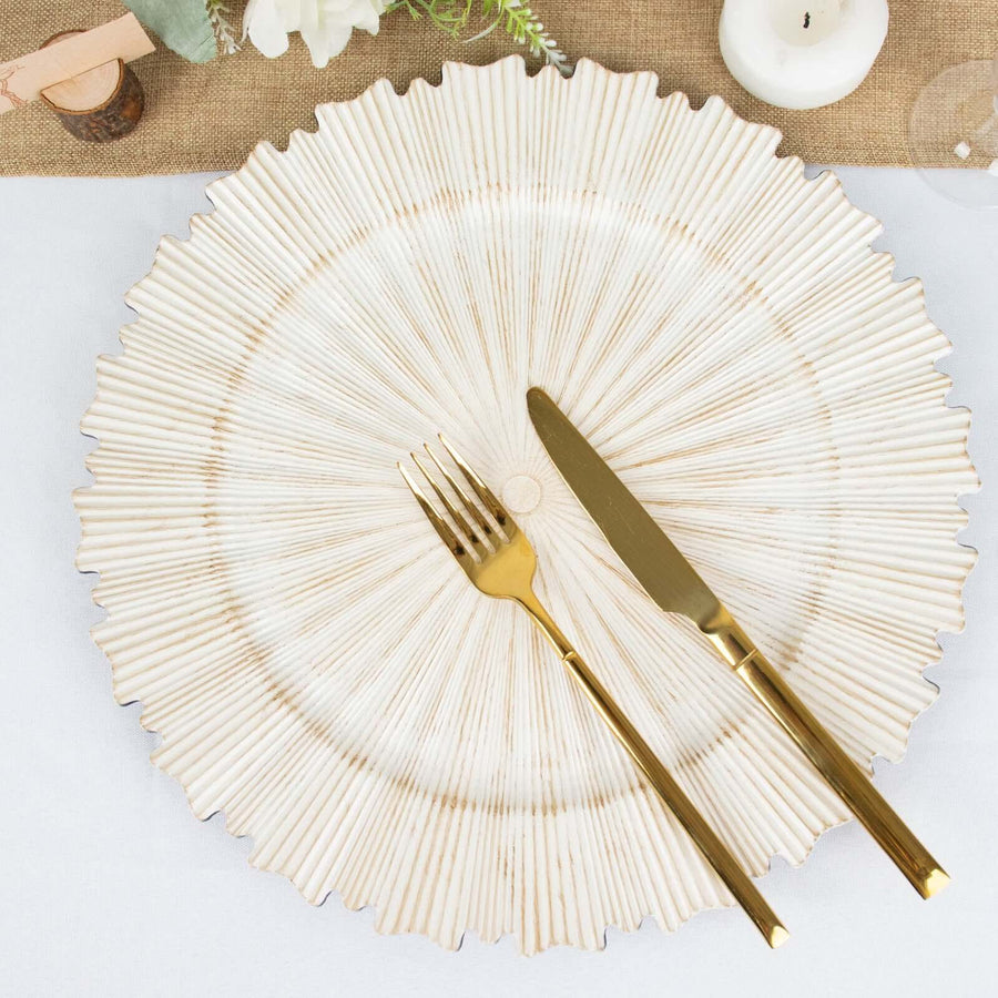 Elegant ridged dinner plate with gold cutlery on a table setting.