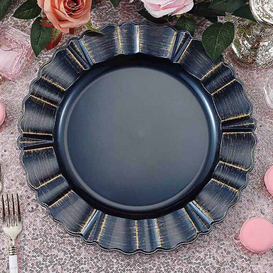 Navy blue scalloped plate on a decorative table setting with flowers.
