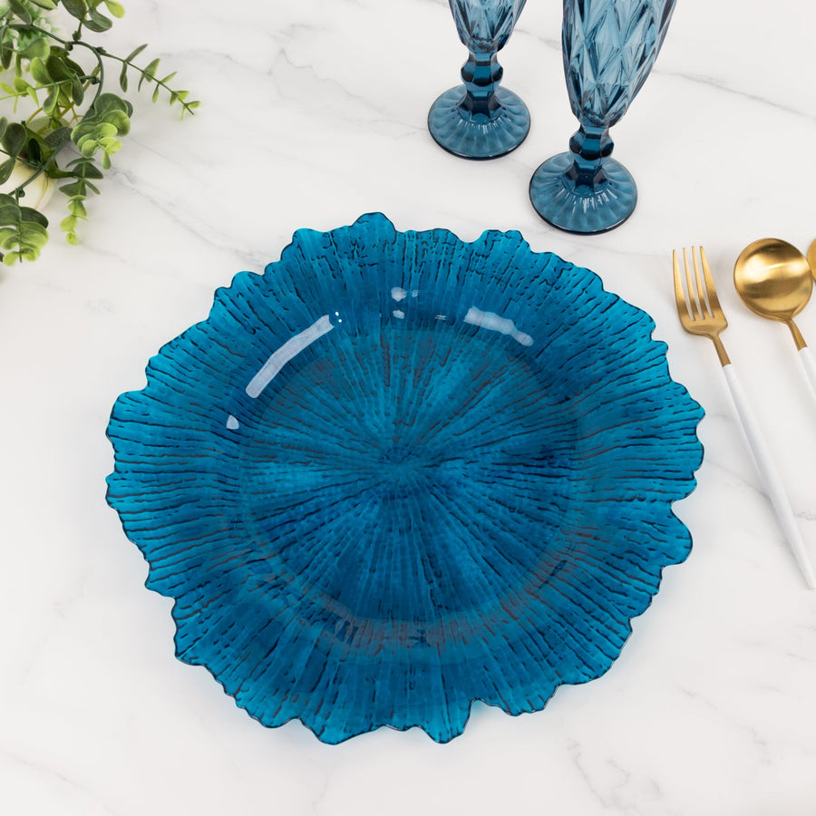 Blue decorative plate with textured design on marble surface.