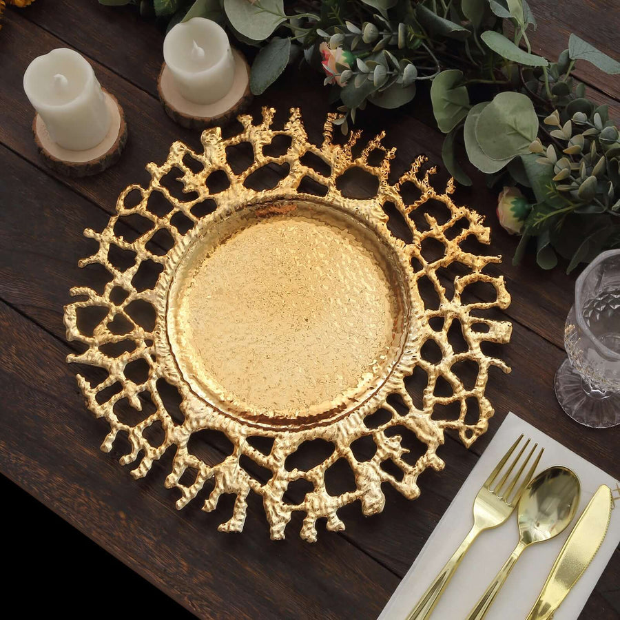 Gold decorative platter with intricate design on wooden table setting.