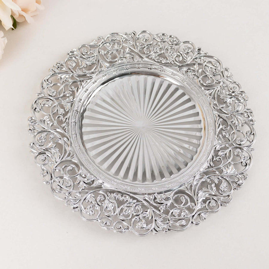 Decorative silver platter with intricate floral design and glass center