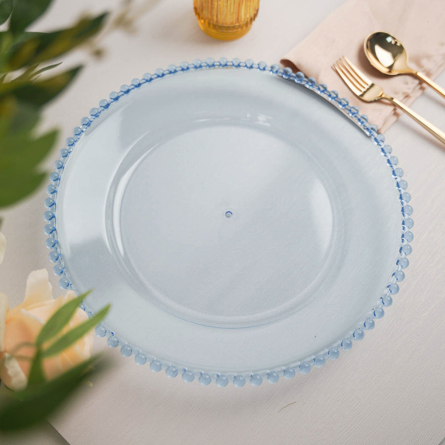 Clear glass plate with blue beaded rim on a neutral table setting.