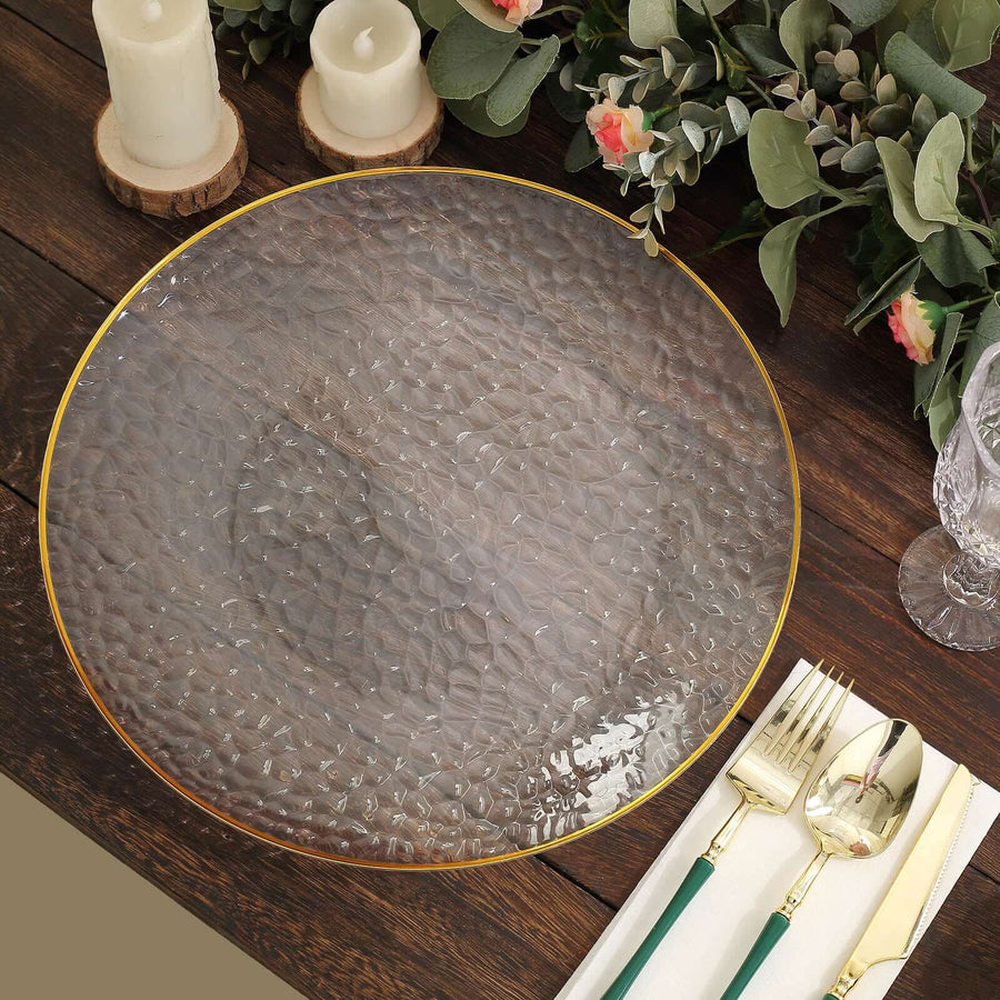 Elegant textured glass plate with gold rim, styled with candles and greenery.