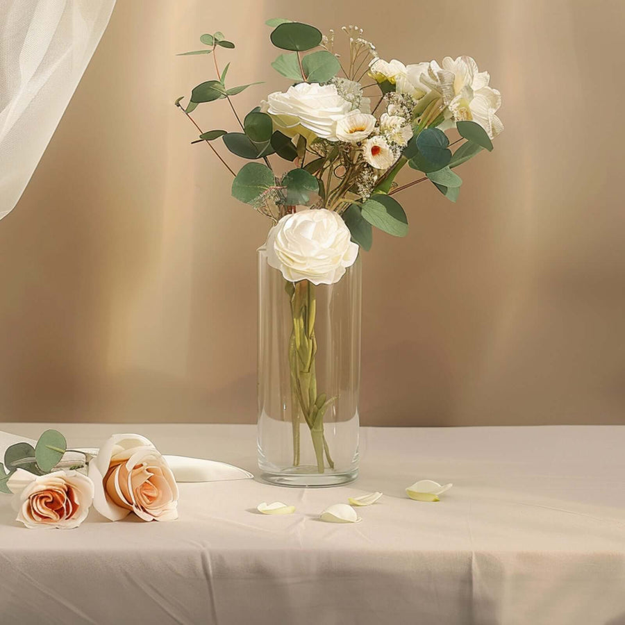 Elegant floral arrangement in a clear vase with soft pastel roses and greenery.