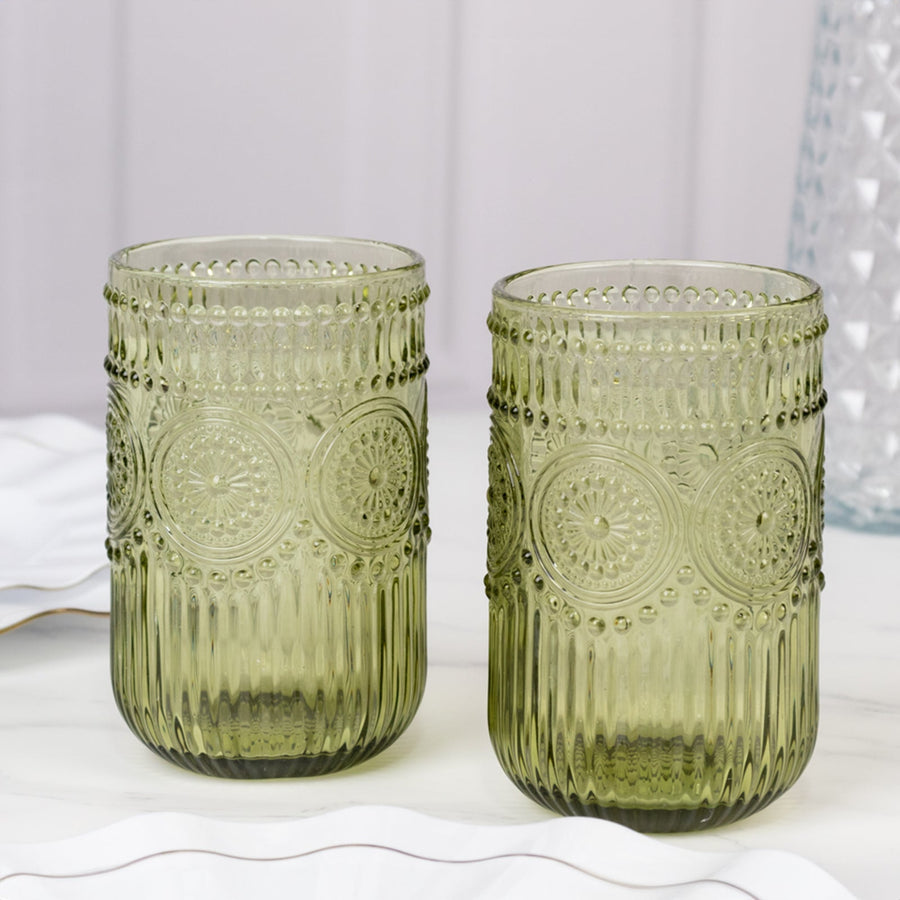 Green textured glass tumblers in a studio-style setting.