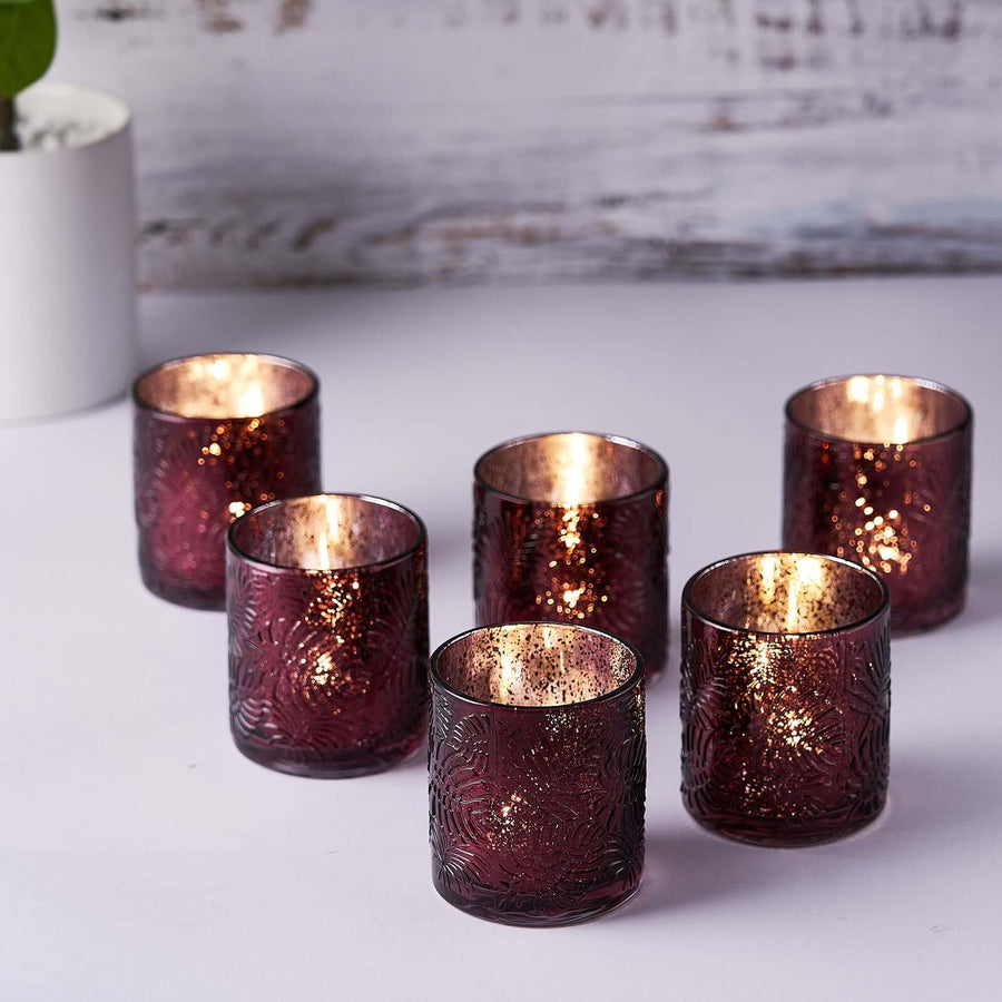 Set of six burgundy glass candle holders with a textured design.