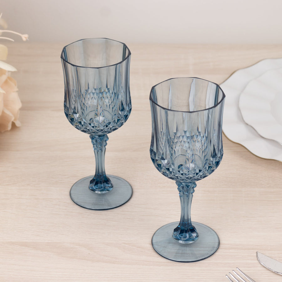 Blue crystal goblets on a wooden table, elegantly designed for dining.