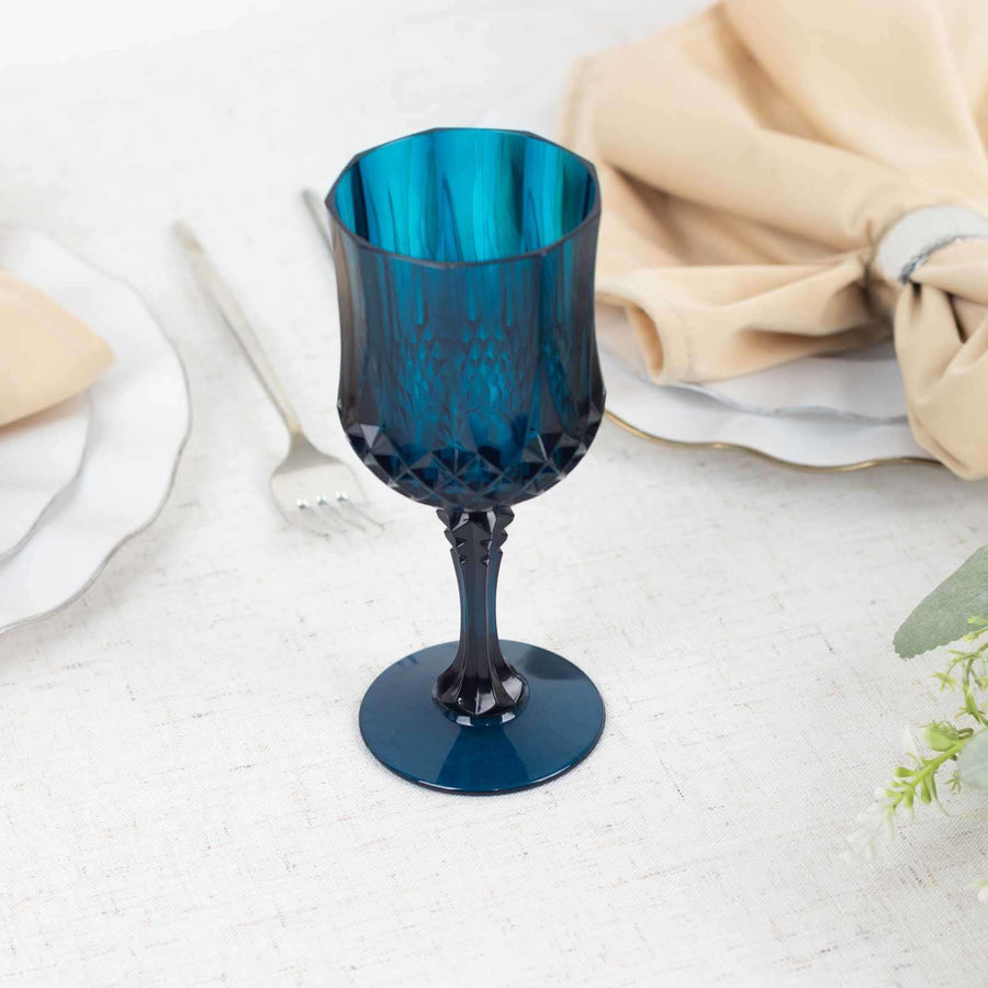 Blue vintage glass goblet on a table setting with napkins and plates.
