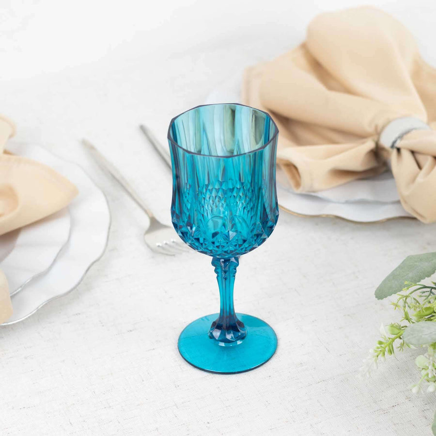 Blue decorative glass goblet on a dining table with napkins and cutlery.