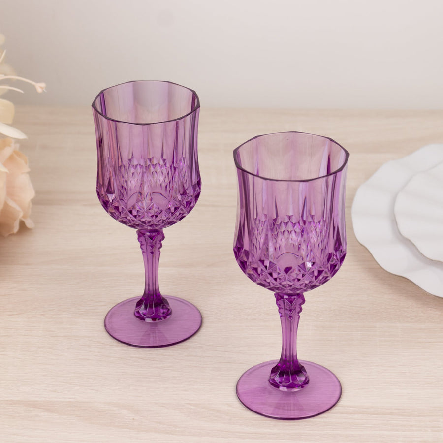 Purple crystal wine glasses on a wooden table.