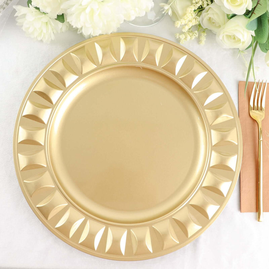 Gold decorative charger plate with elegant leaf design on a table setting.