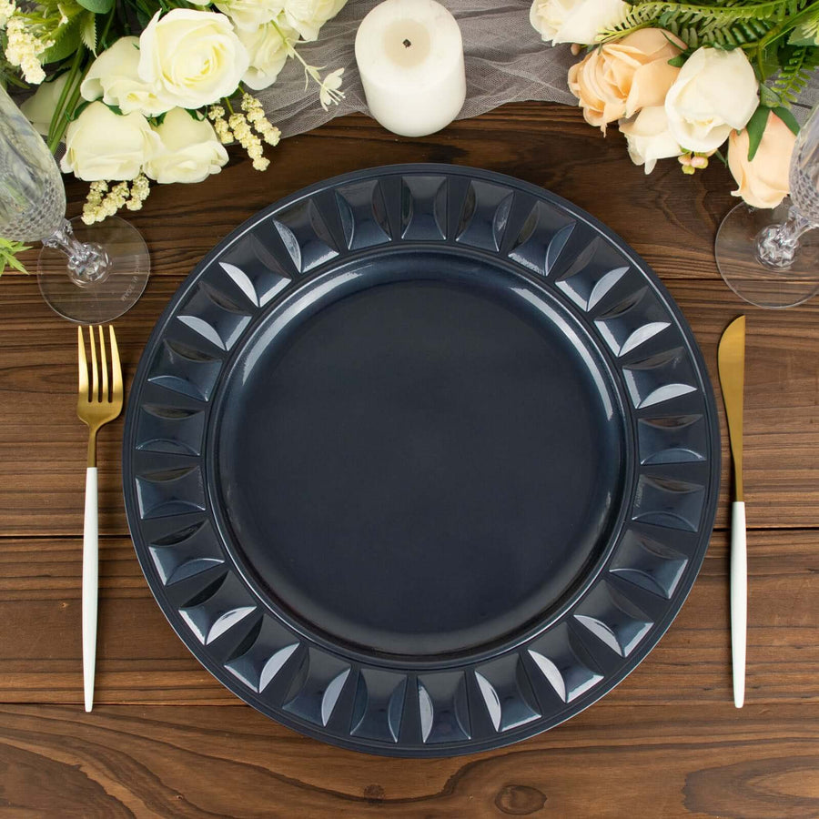 Elegant navy blue dinner plate with decorative edge on a wooden table setting.