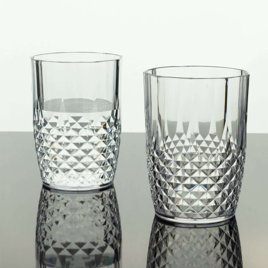 Crystal tumblers with geometric patterns, one filled with water.