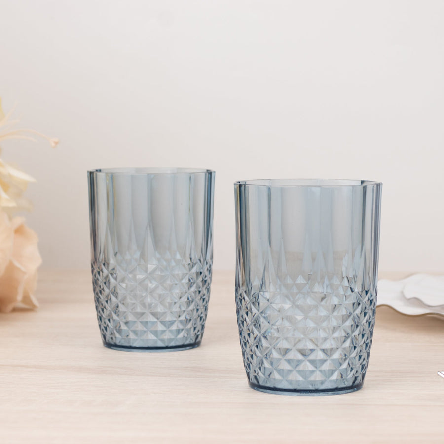 Blue patterned drinking glasses set on a wooden surface.
