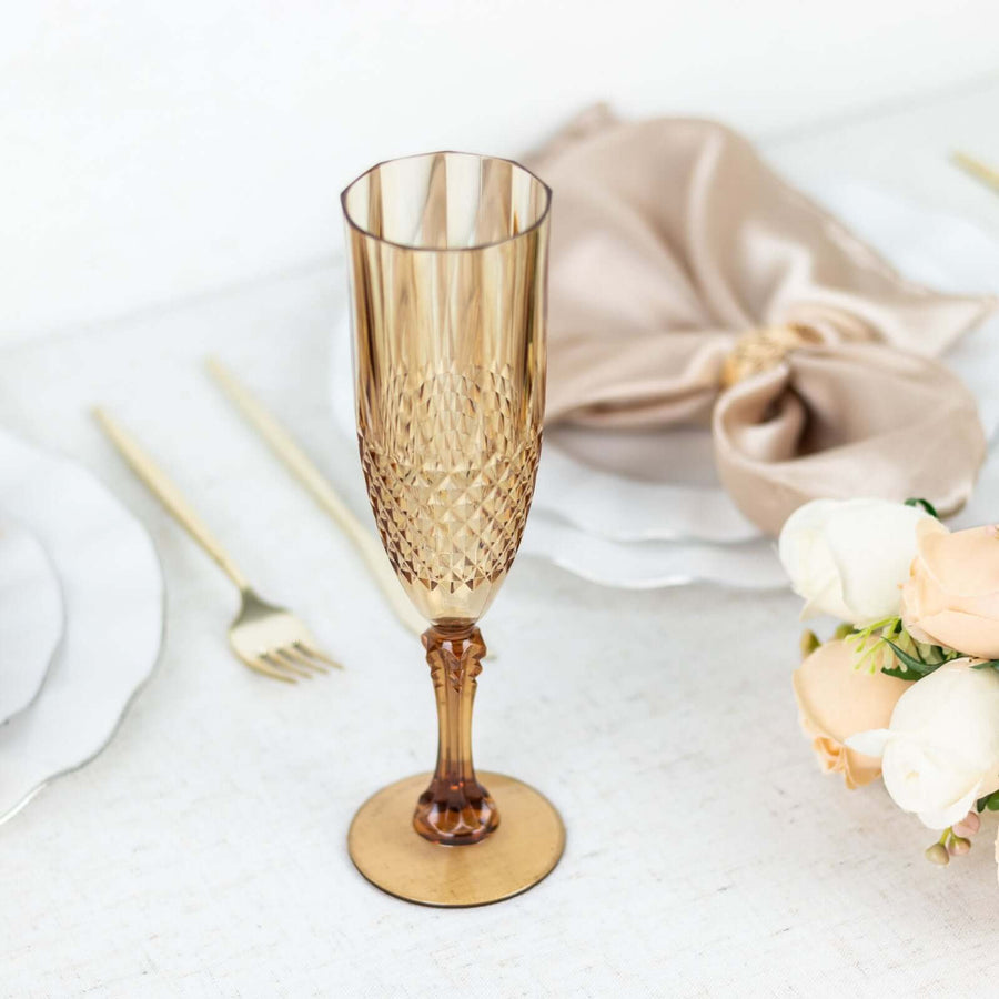 Elegant amber champagne flute on a table setting with gold accents.
