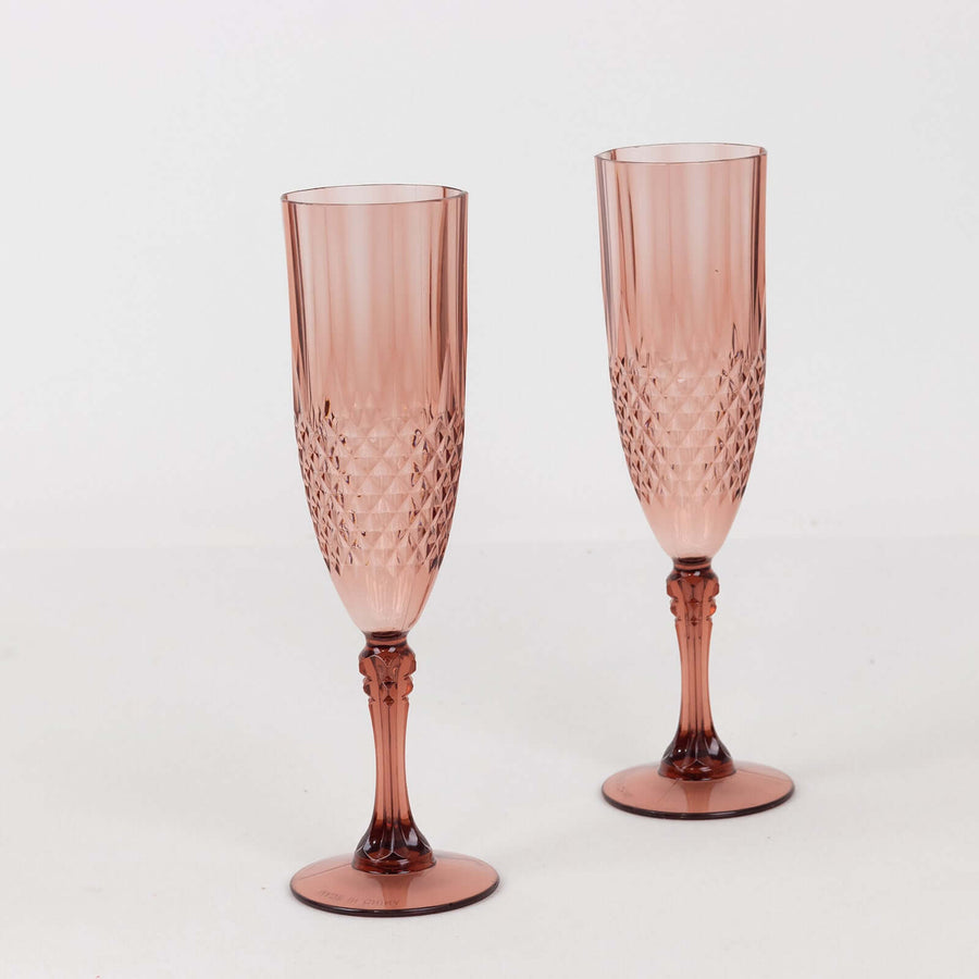 Two elegant pink champagne flutes on a white background.