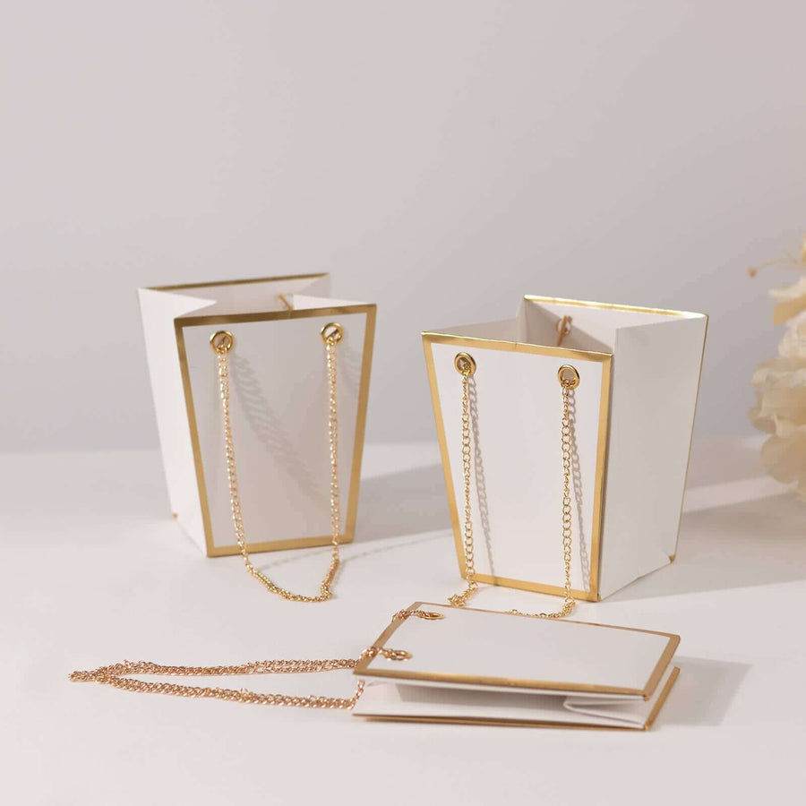 Elegant white gift bags with gold accents and chains