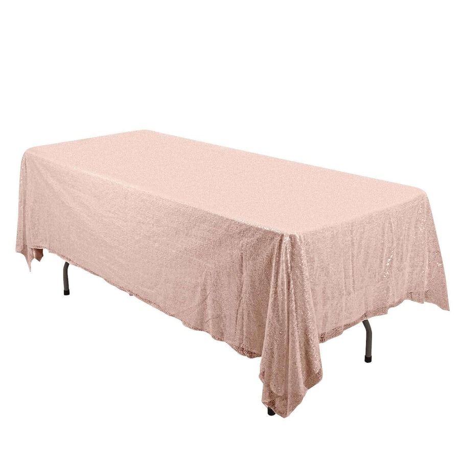 Blush pink sequined tablecloth draped over a rectangular table