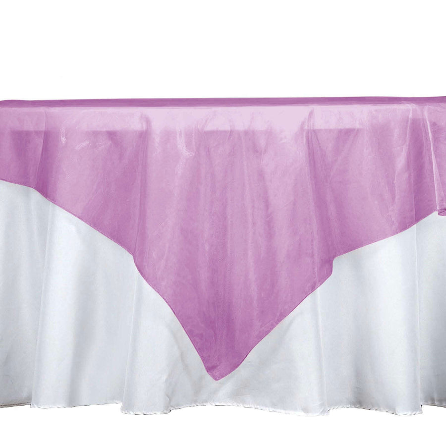 Purple table cover on a white tablecloth for elegant dining decor