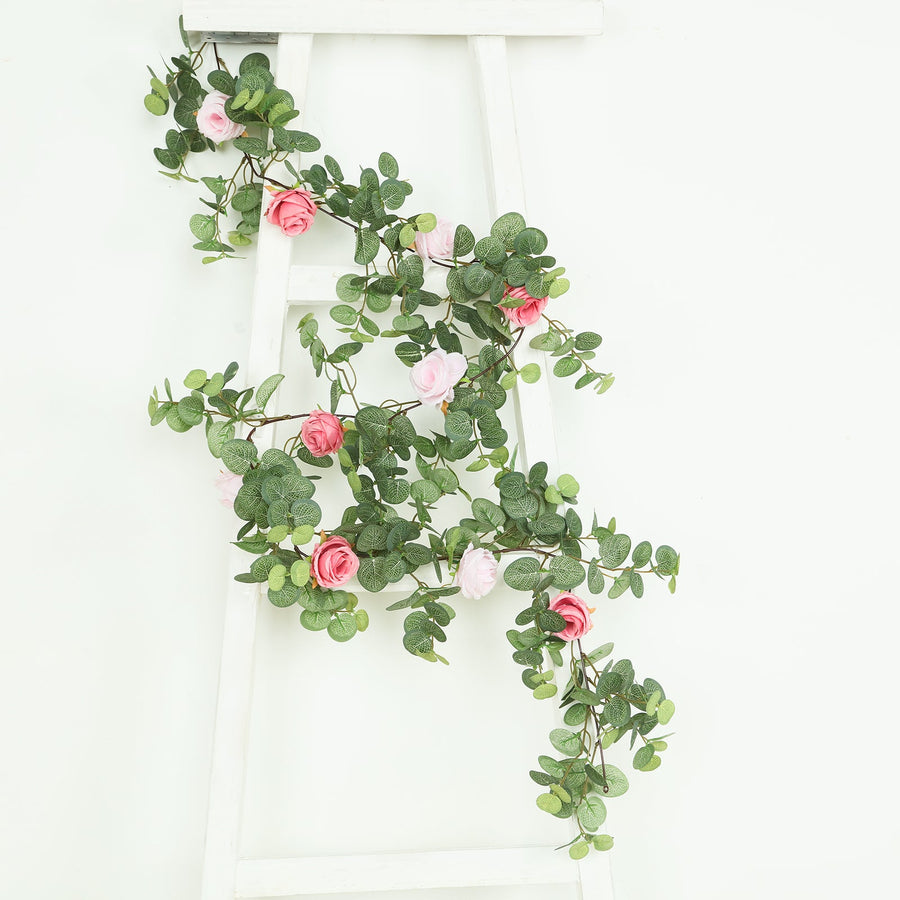 Artificial greenery garland with pink roses on a white ladder