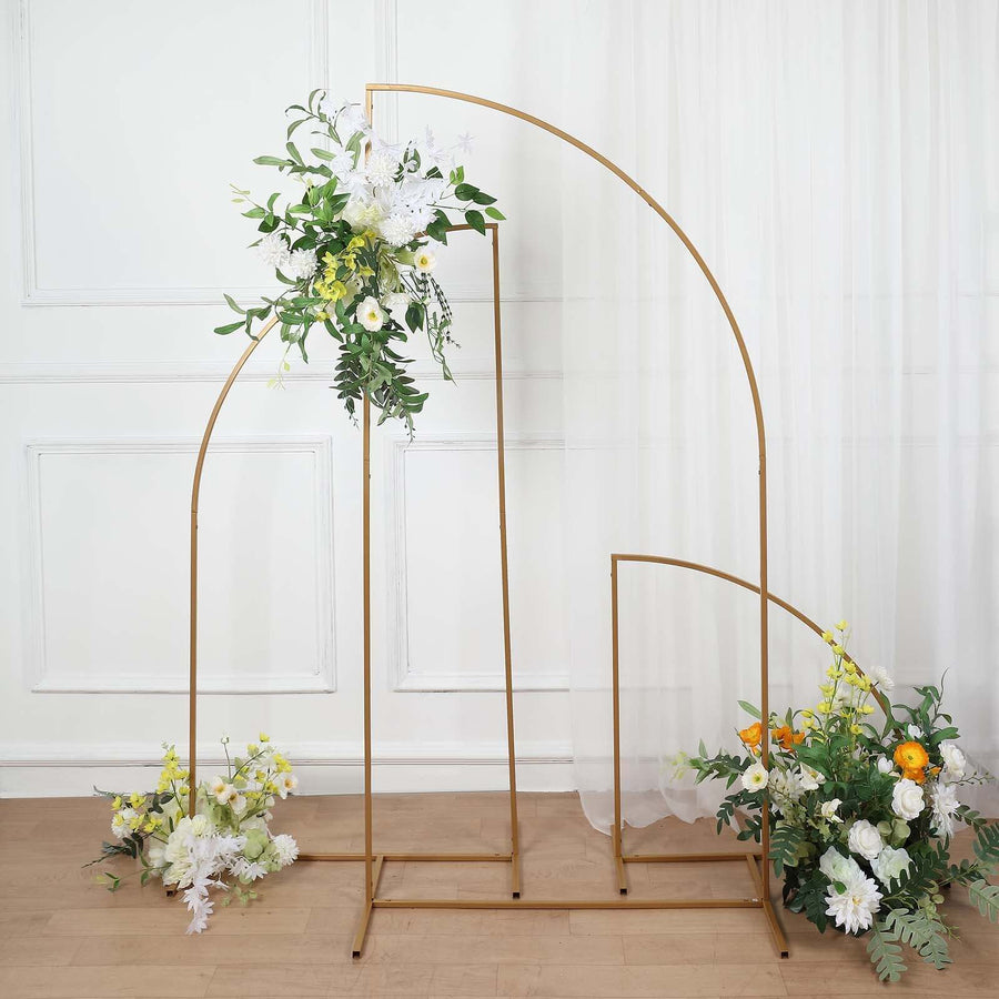 Gold floral arch with white and yellow flowers in a staged setting.