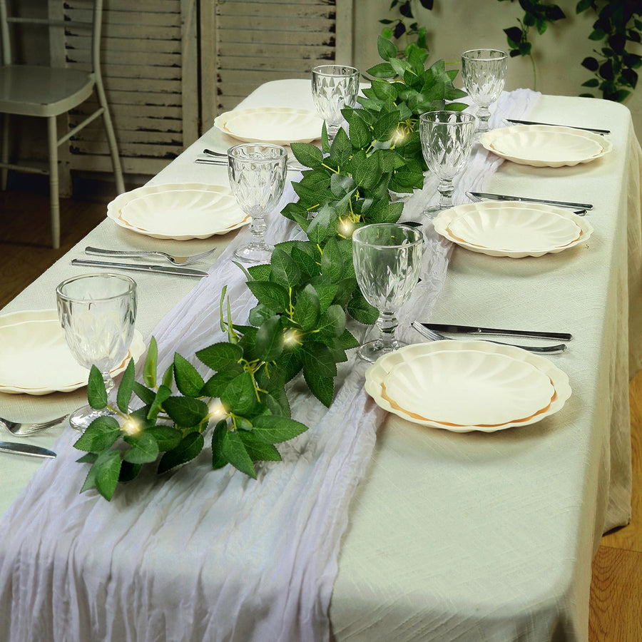 Elegant table setting with greenery and decorative plates for a stylish dining experience.