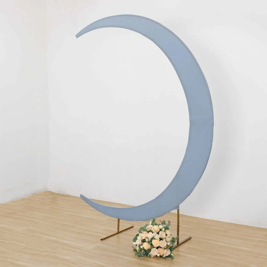 Blue crescent moon backdrop with floral arrangement for events and photography.