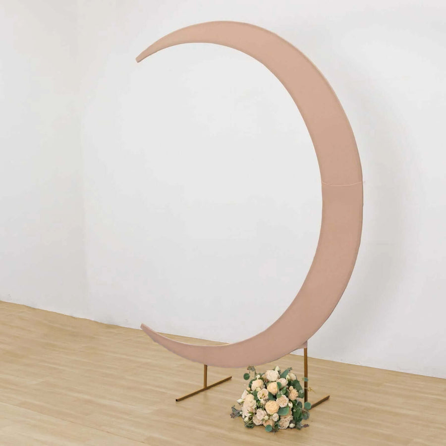 Pink crescent moon backdrop stand with floral arrangement at the base