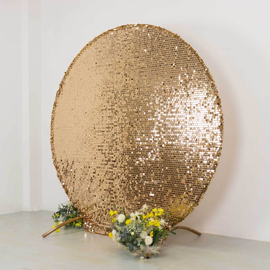 Gold sequin backdrop with floral arrangement at the base.