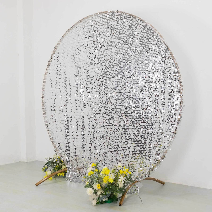 Silver sequin backdrop with floral arrangement at the base