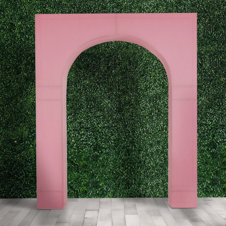 Pink archway decoration for events against a greenery backdrop.