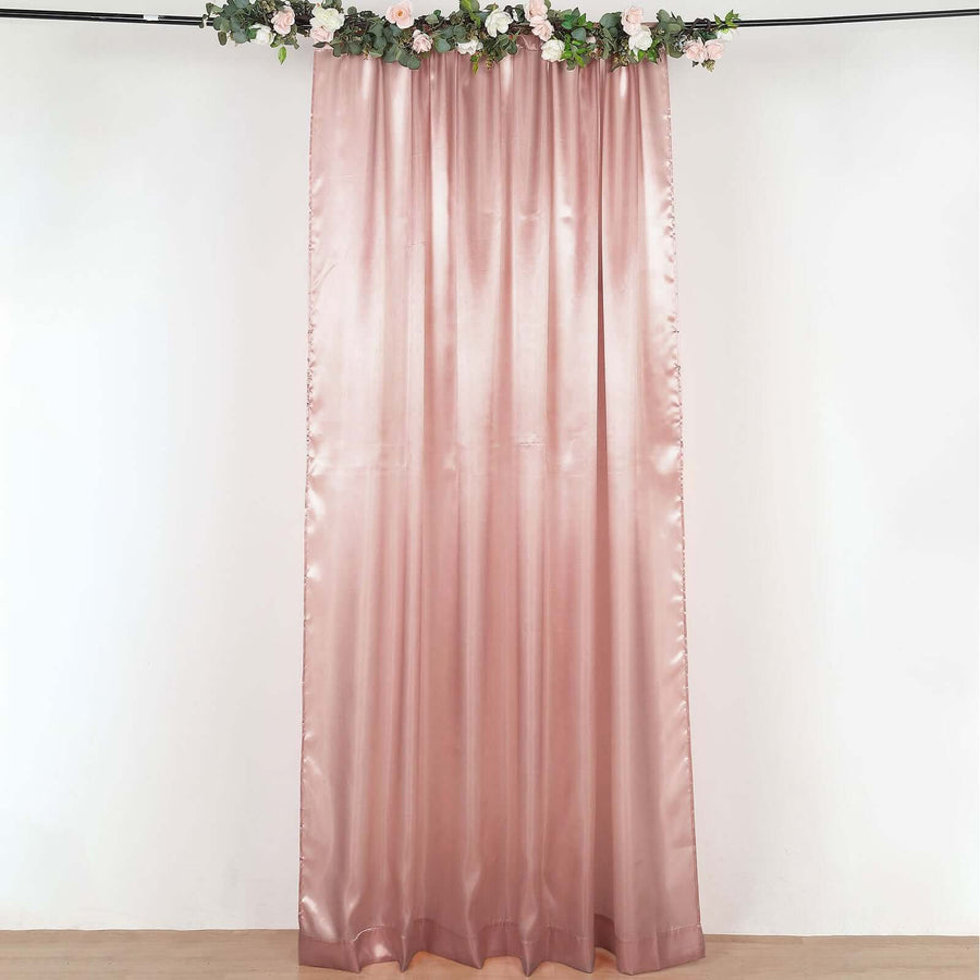 Pink satin curtain with floral greenery at the top