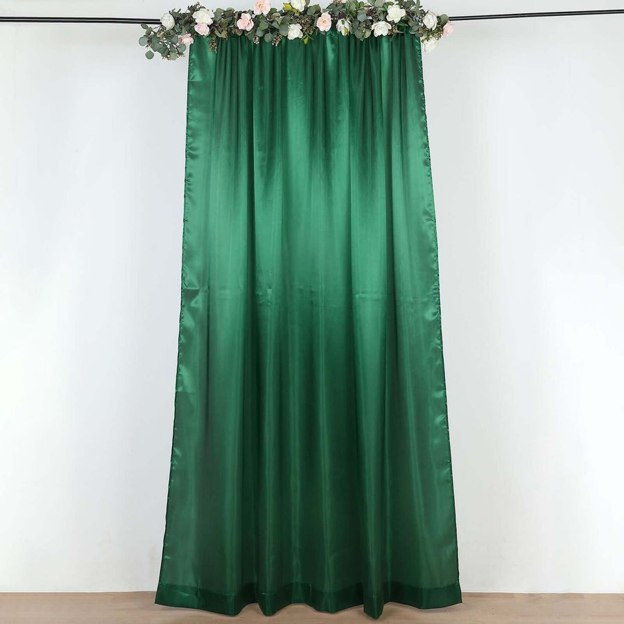 Emerald green curtain backdrop with floral top detail