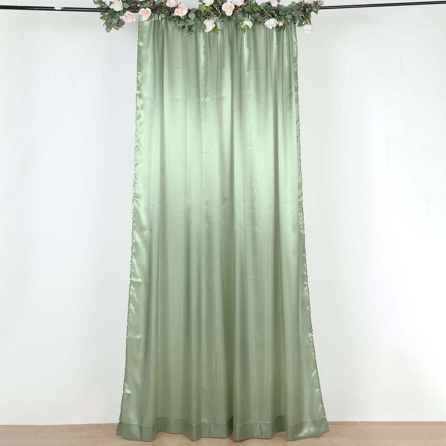 Sage green satin curtain panel hanging in a decorated room