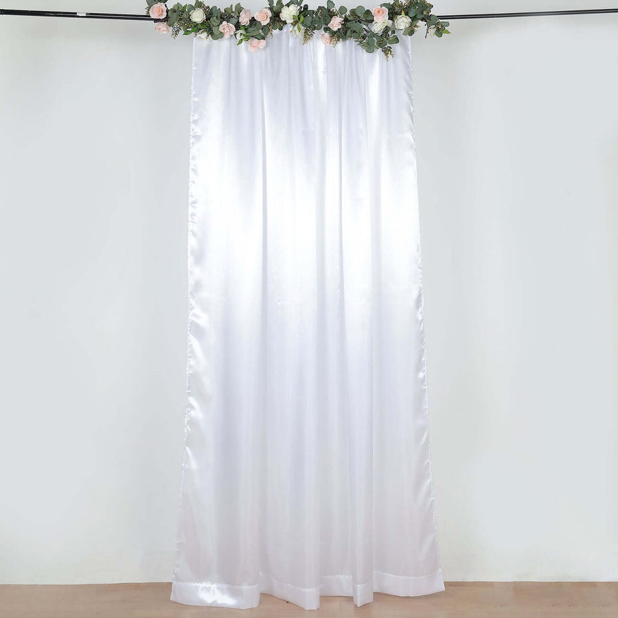 White satin curtain with floral decoration at the top