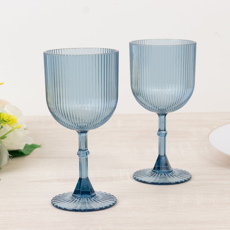 Blue ribbed glassware set on a light wooden surface.