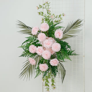 Floral wall decor with pink roses and chrysanthemums on greenery backdrop.