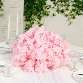 Pink artificial flower centerpiece for elegant table settings.