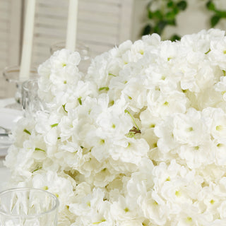 White artificial flowers bouquet arrangement on a table.
