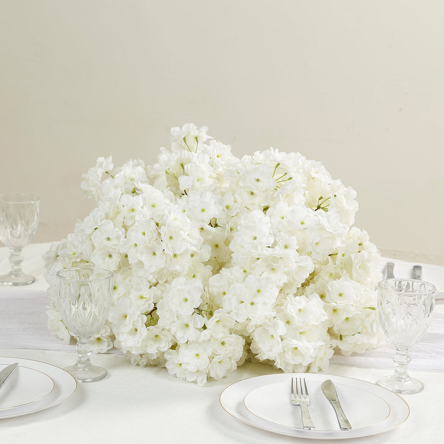 White floral centerpiece arrangement on a dining table