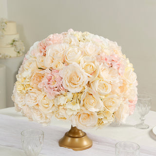 Elegant floral centerpiece with soft pink and cream roses in a gold vase.