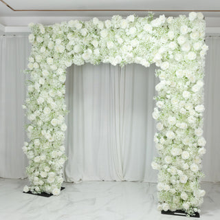 White floral arch adorned with roses and greenery for events and weddings.