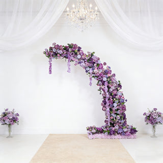 Purple floral arch with cascading blooms against a white background.