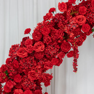 Vibrant red floral arrangement cascading elegantly against a white backdrop.