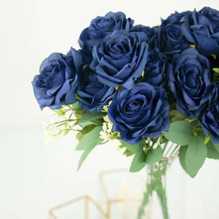 Navy blue artificial roses bouquet in a clear vase.