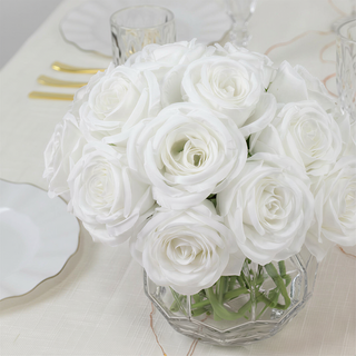 White roses bouquet in a clear glass vase.