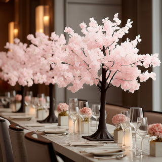 Artificial cherry blossom tree centerpiece for elegant dining.
