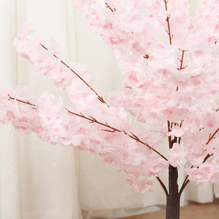 Artificial pink cherry blossom tree with delicate flowers and branches.