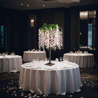 Elegant floral centerpiece on a banquet table in a sophisticated dining setting.